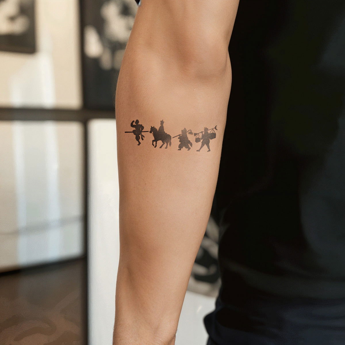 A Wukong / journey to the west tattoo on a man's arm in the background of tattoo shop - Wide Awake NYC